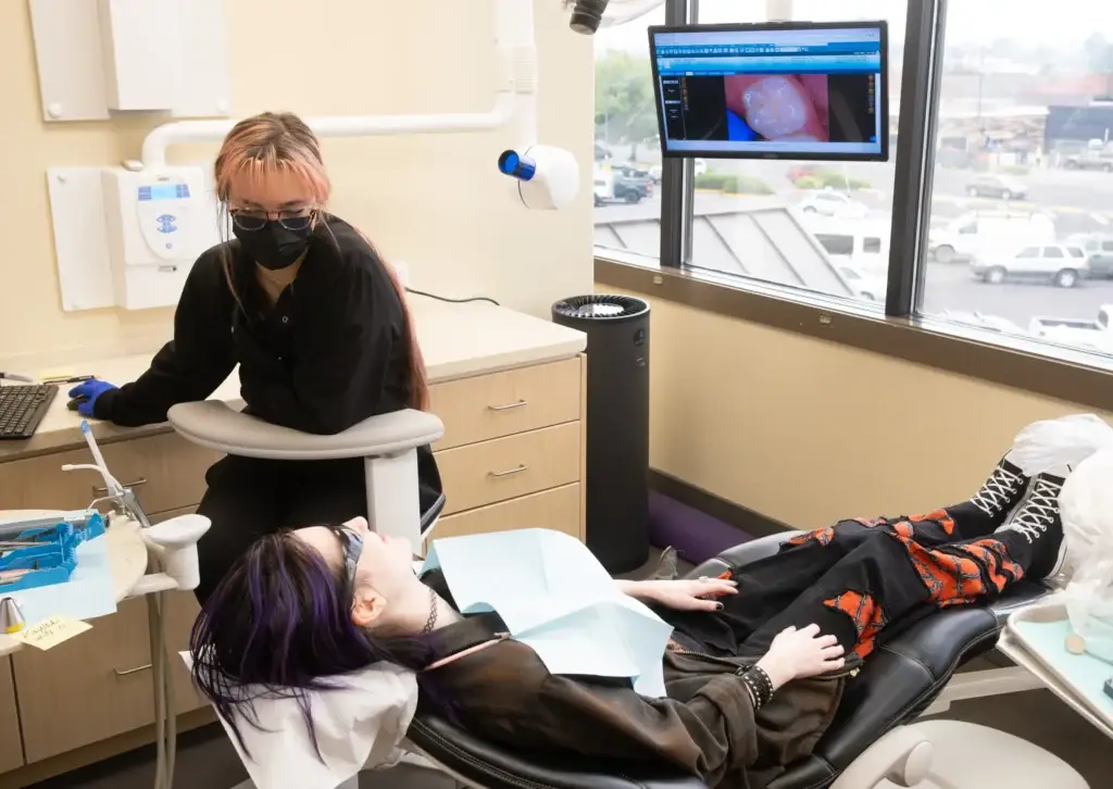 patient on dental chair receiving dental treatment