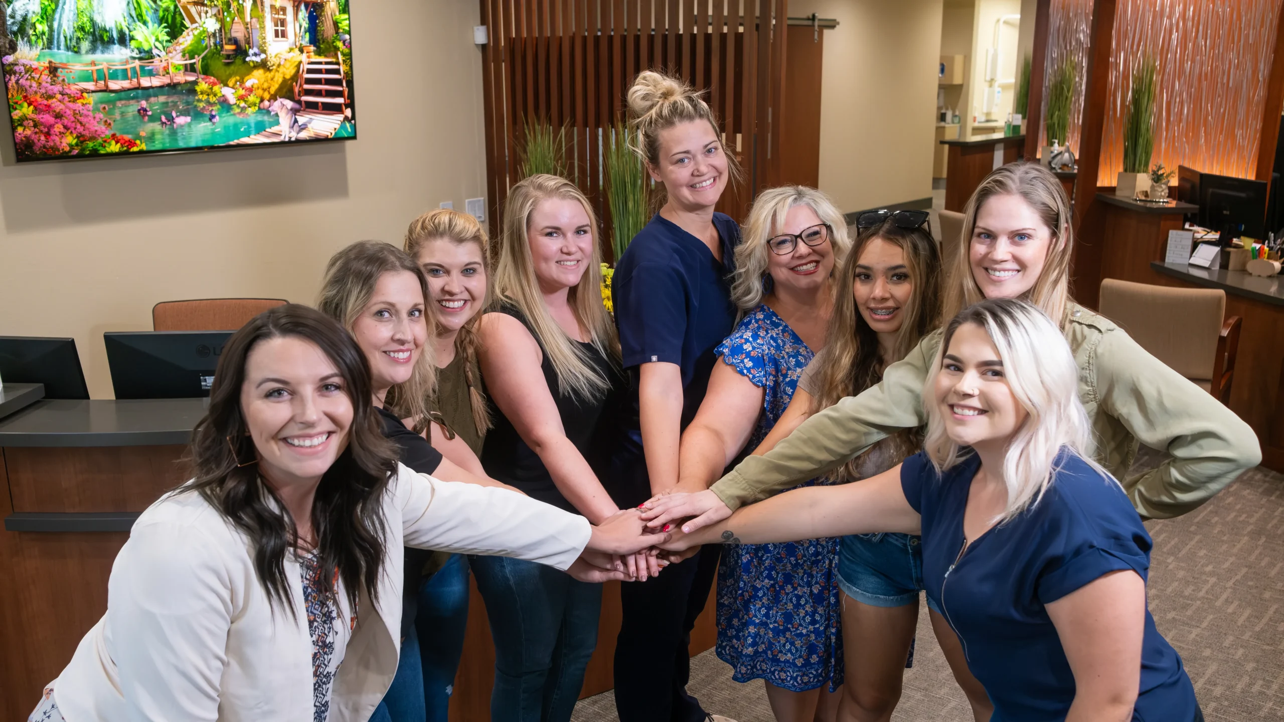 bend family staff uniting hands 